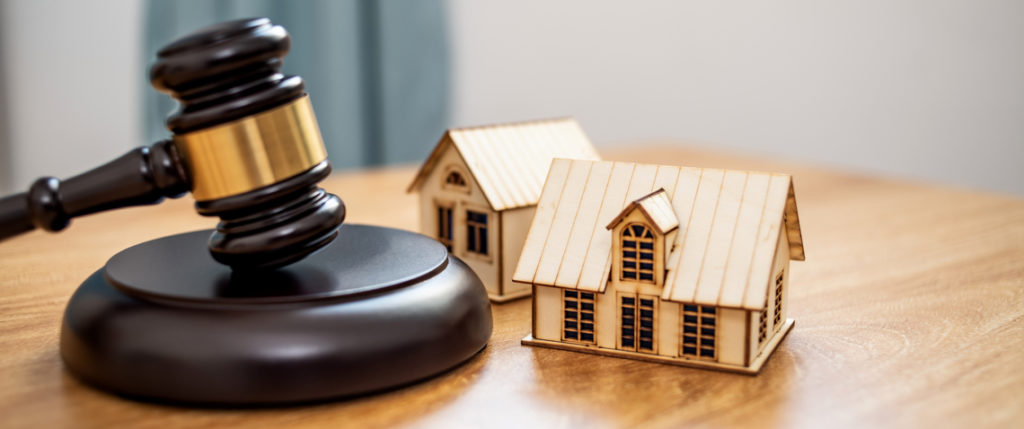 A gavel with a house beside it resembling fair housing laws
