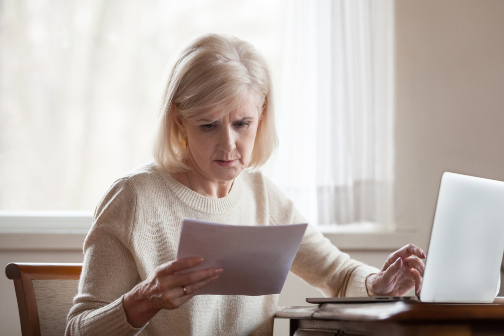 Senior woman looking at bills