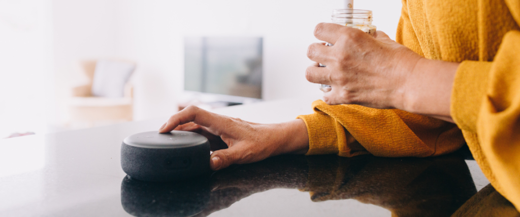 Person turning on a smart speaker